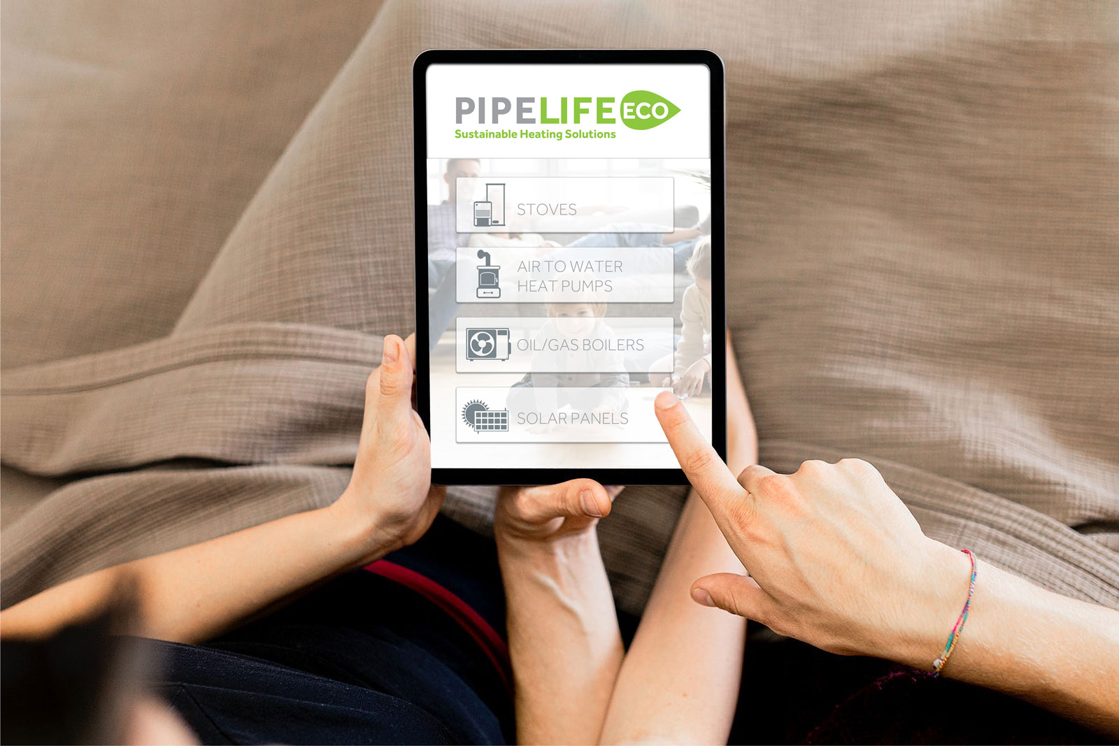 people pointing at a tablet showing pipelife products