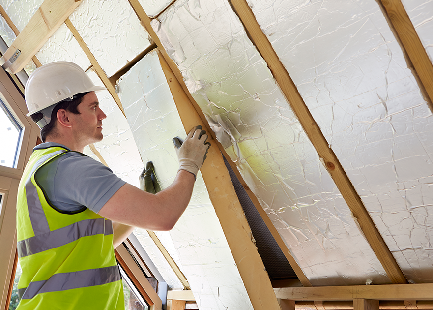 contractor installing insulation