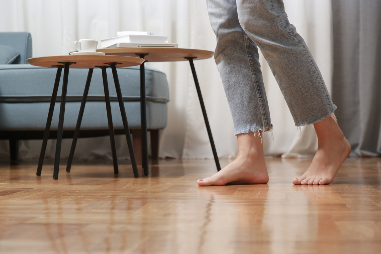 woman walking barefoot on wood floor