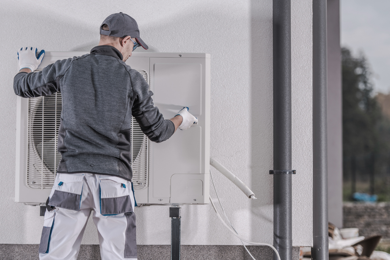 man fitting a heat pump