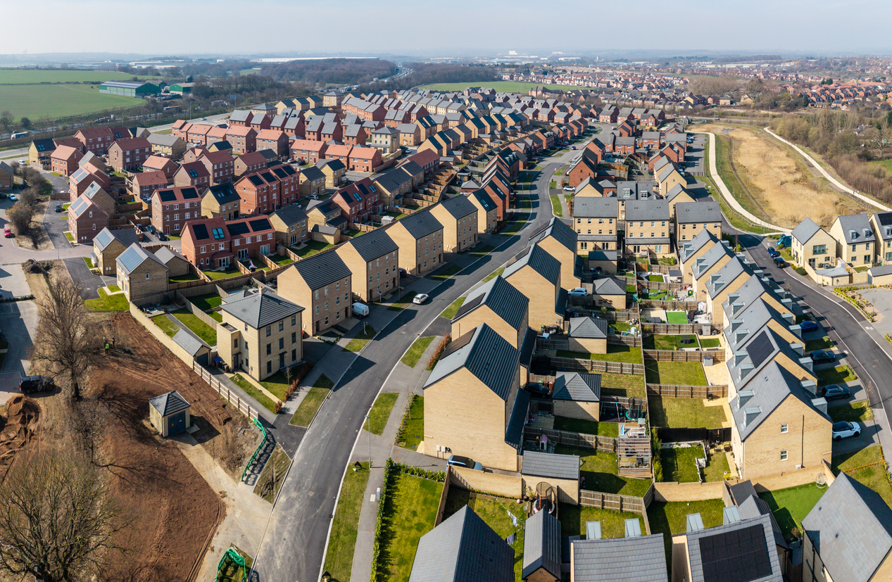 Aerial view of a new build housing estate with houses in a row